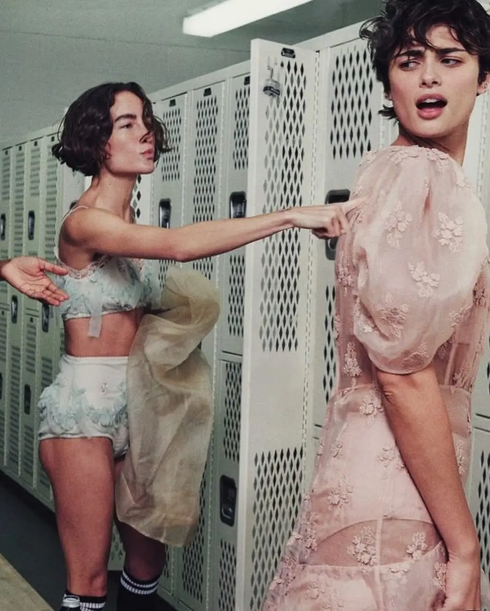 ROMP editorial photography: a figure mid stride in a sheer slip dress and fishnets.